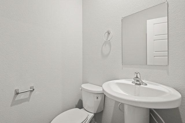 bathroom featuring sink and toilet