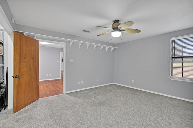 spare room with carpet and ceiling fan