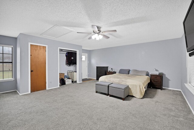 bedroom with ceiling fan, light carpet, and a textured ceiling