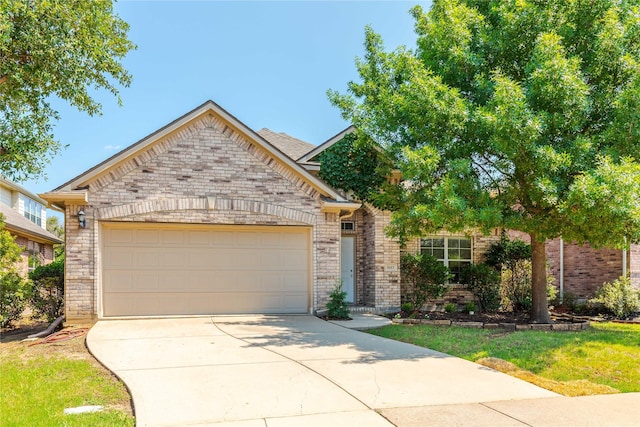 view of front of property featuring a garage and a front yard