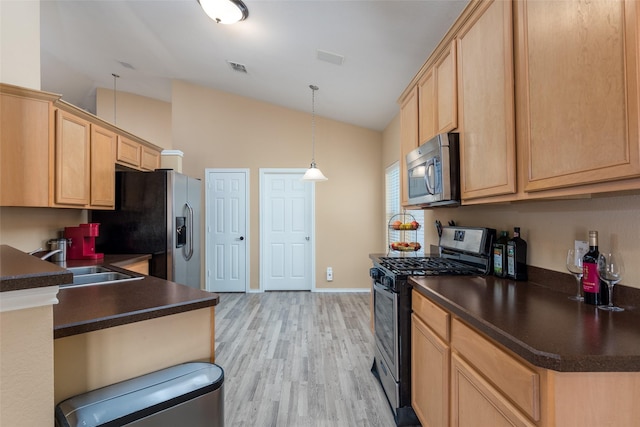 kitchen featuring stainless steel appliances, sink, light brown cabinets, light hardwood / wood-style flooring, and lofted ceiling