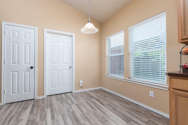 unfurnished dining area featuring light wood-type flooring