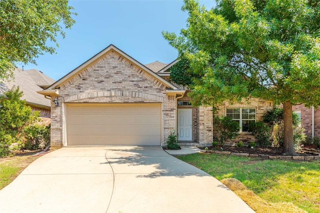 view of front of home featuring a garage and a front lawn