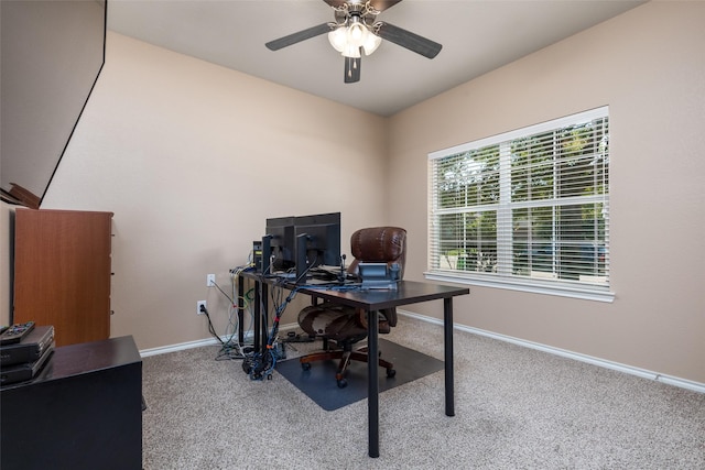 carpeted office space featuring ceiling fan