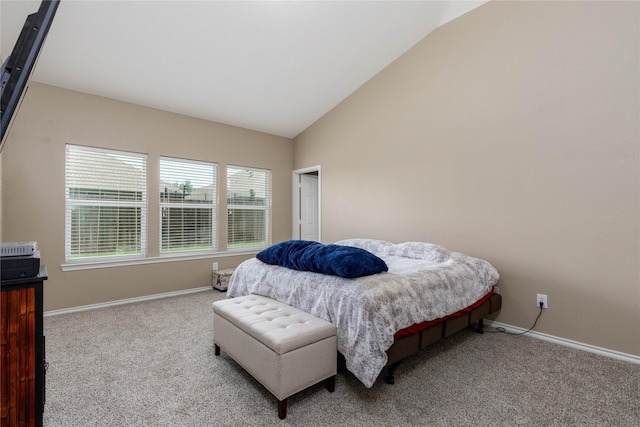 carpeted bedroom featuring vaulted ceiling