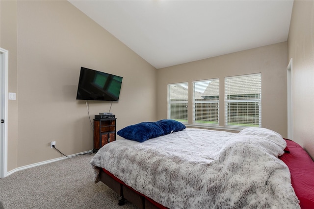 bedroom with carpet floors and lofted ceiling