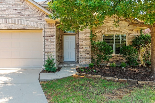 view of exterior entry with a garage