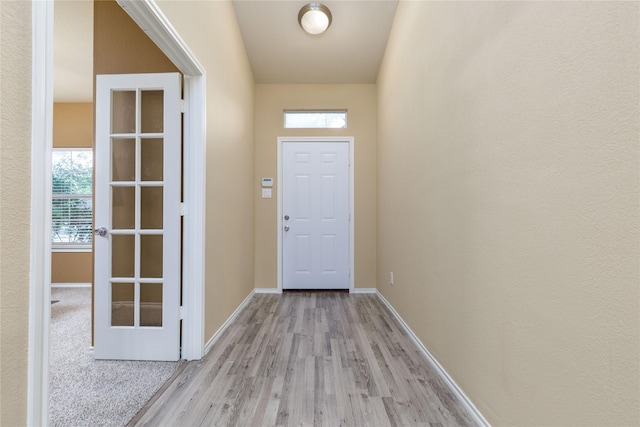 entryway featuring light hardwood / wood-style flooring and french doors