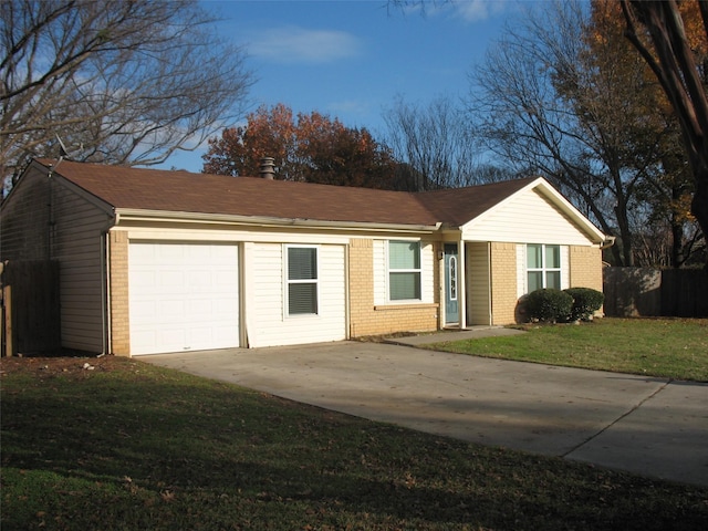 ranch-style house featuring a garage and a front lawn