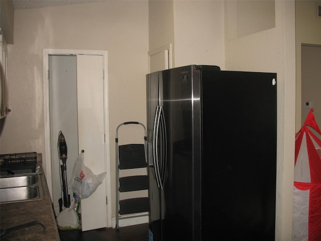 kitchen featuring sink and stainless steel refrigerator with ice dispenser