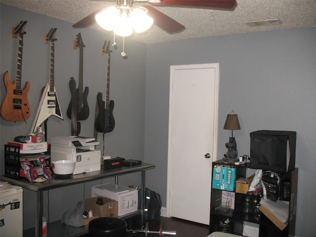 interior space featuring ceiling fan and a textured ceiling