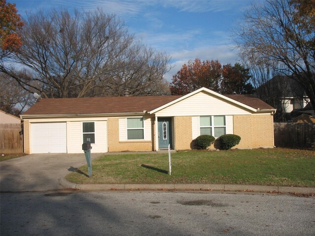 ranch-style house featuring a front lawn and a garage