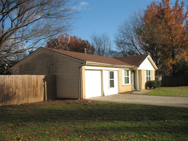 exterior space featuring a garage and a yard