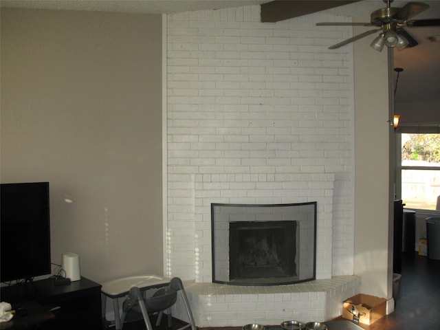 living room with a brick fireplace, vaulted ceiling, ceiling fan, and hardwood / wood-style floors