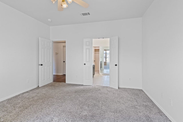 unfurnished bedroom with light colored carpet and ceiling fan