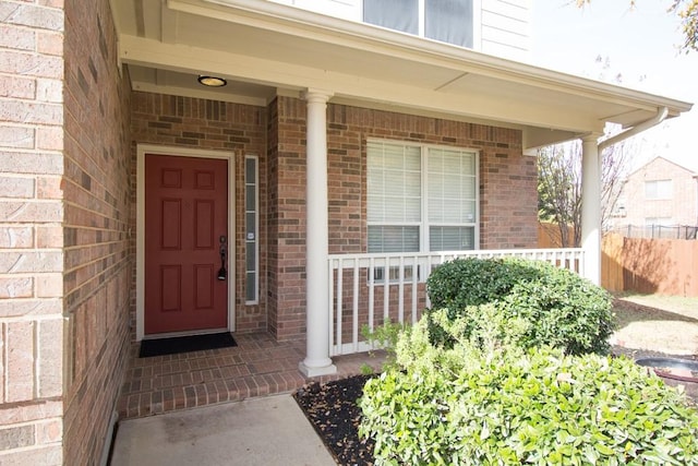 view of exterior entry featuring a porch