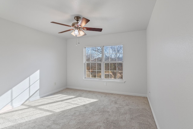 spare room featuring ceiling fan and light colored carpet