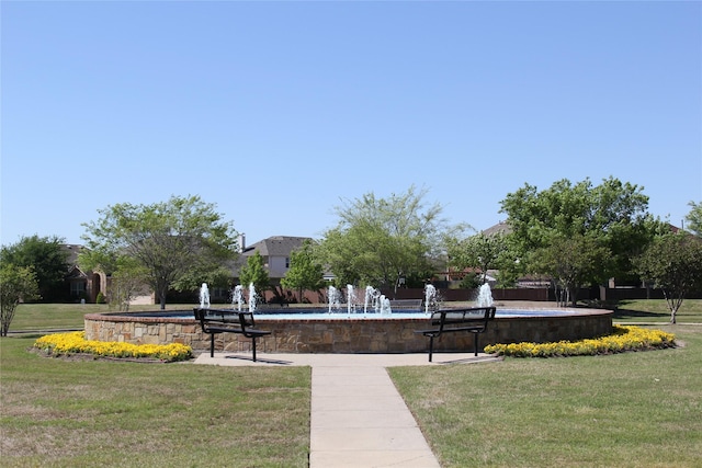 view of property's community with a yard