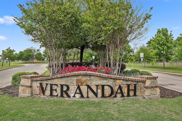 community / neighborhood sign featuring a lawn