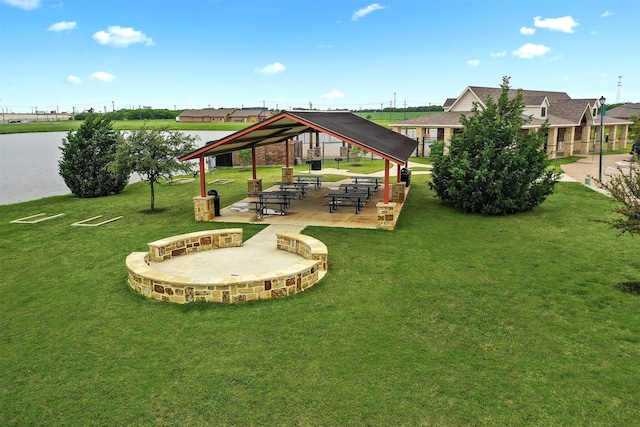 view of home's community with a water view, a yard, a patio area, and a gazebo