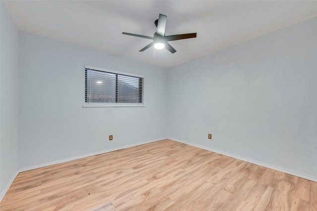 spare room with ceiling fan and light wood-type flooring