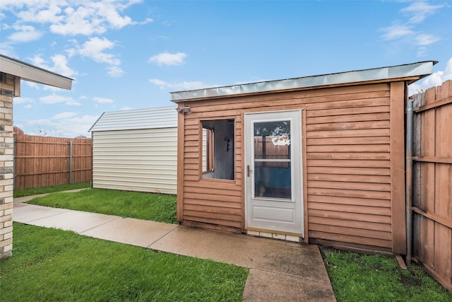 view of outbuilding featuring a lawn