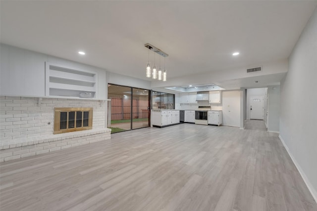 unfurnished living room featuring light wood-type flooring and a fireplace