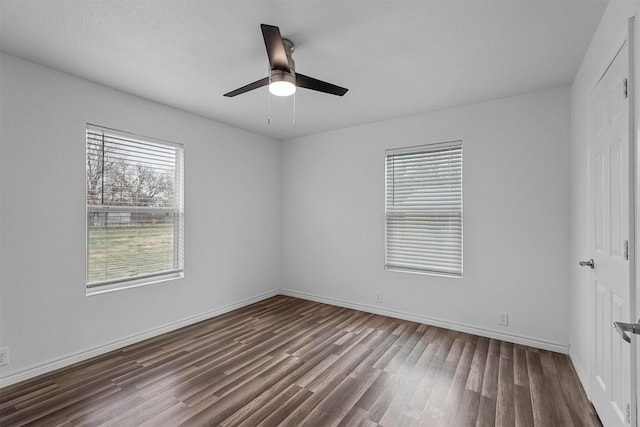 empty room with dark hardwood / wood-style flooring and ceiling fan