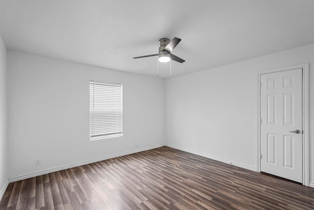 spare room featuring dark hardwood / wood-style floors and ceiling fan