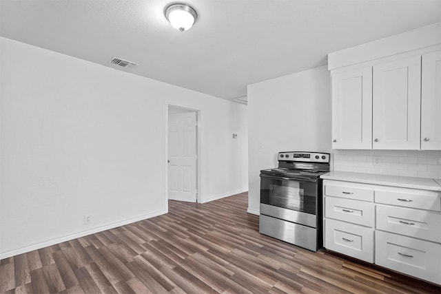 kitchen featuring stainless steel electric range oven, dark hardwood / wood-style floors, white cabinets, and backsplash