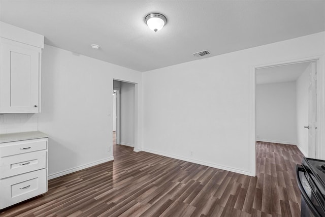 unfurnished living room with dark hardwood / wood-style flooring