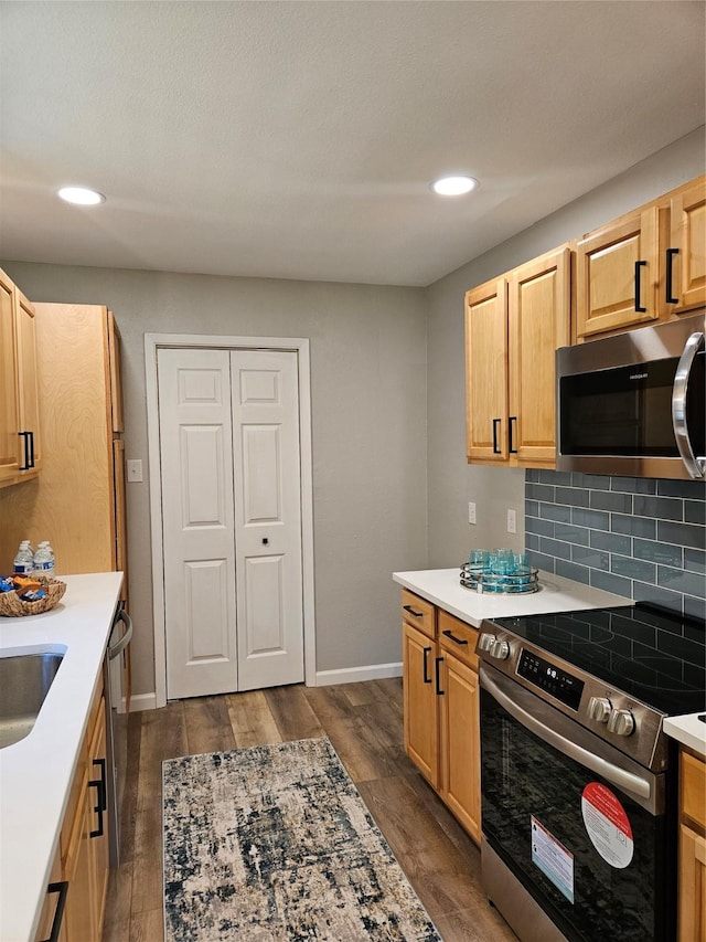 kitchen with dark wood-type flooring, sink, light brown cabinetry, tasteful backsplash, and stainless steel appliances