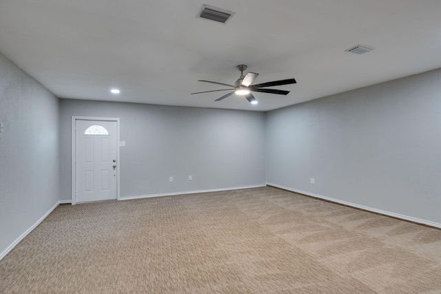 carpeted spare room featuring ceiling fan