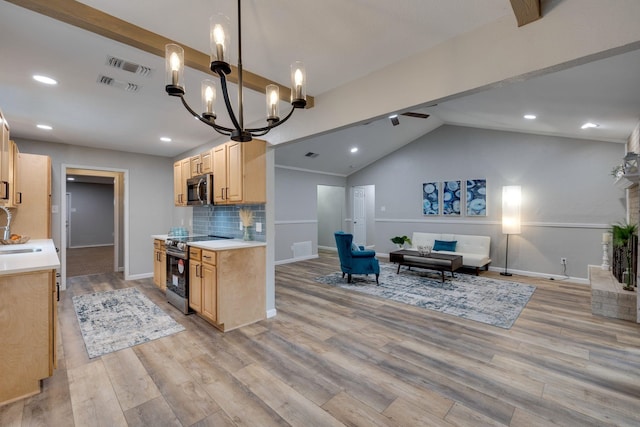 kitchen featuring hanging light fixtures, stainless steel appliances, vaulted ceiling, and light brown cabinets