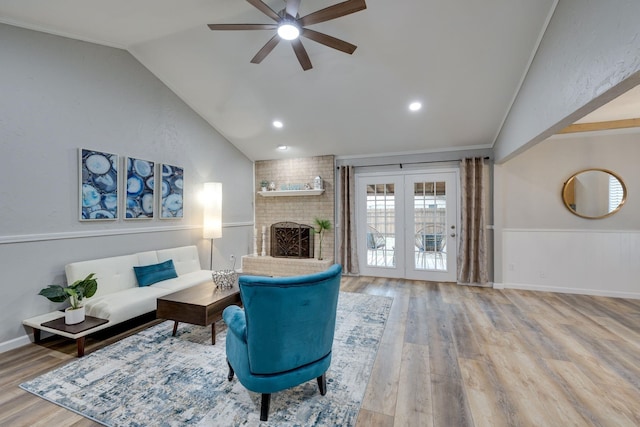 living room with french doors, vaulted ceiling, crown molding, and wood-type flooring