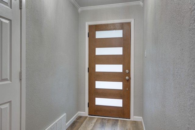 entryway featuring light hardwood / wood-style flooring and ornamental molding