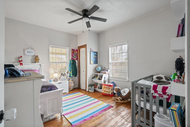 bedroom featuring ceiling fan, light hardwood / wood-style floors, and a closet