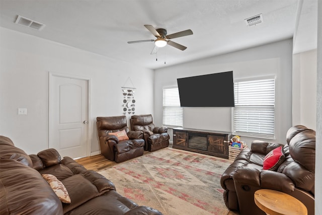 living room with ceiling fan and light wood-type flooring