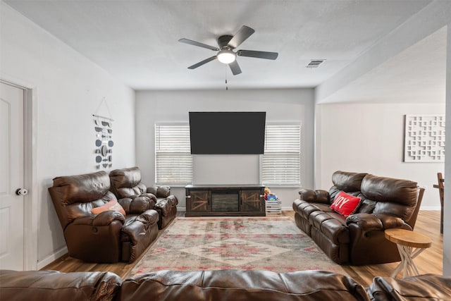 living room with hardwood / wood-style flooring, a fireplace, and ceiling fan