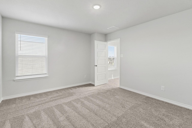 carpeted empty room with plenty of natural light