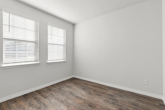 unfurnished room featuring dark wood-type flooring