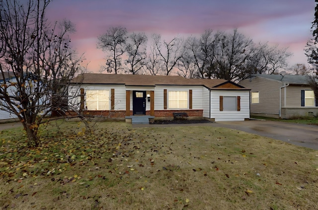 ranch-style home featuring a lawn