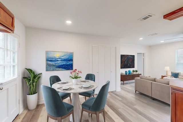 dining area featuring light hardwood / wood-style flooring and a healthy amount of sunlight