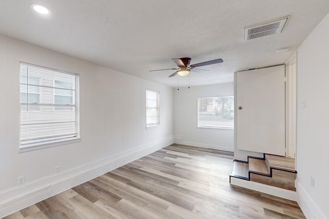 spare room with ceiling fan and light hardwood / wood-style flooring