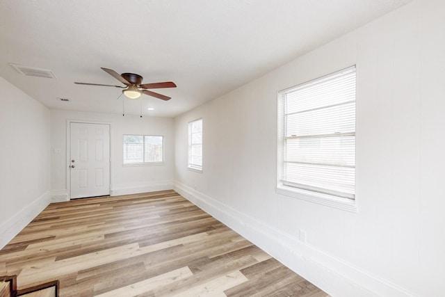 empty room with light wood-type flooring and ceiling fan