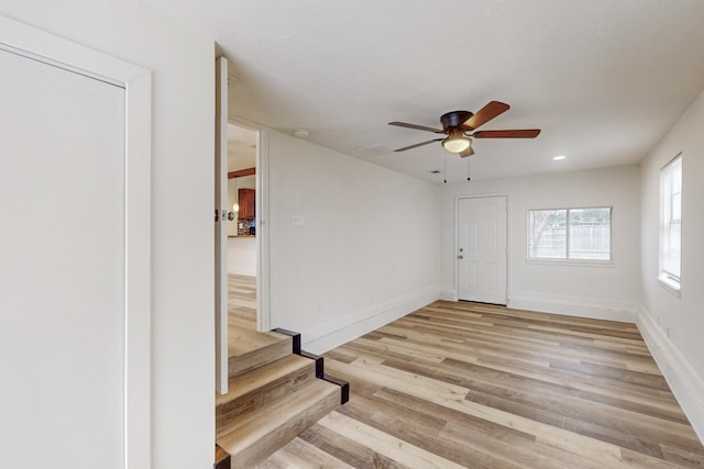 foyer entrance featuring light wood-type flooring and ceiling fan