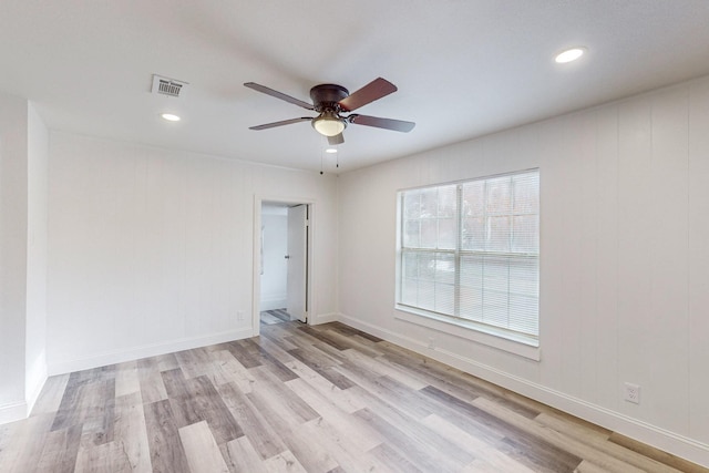 spare room with ceiling fan and light hardwood / wood-style flooring