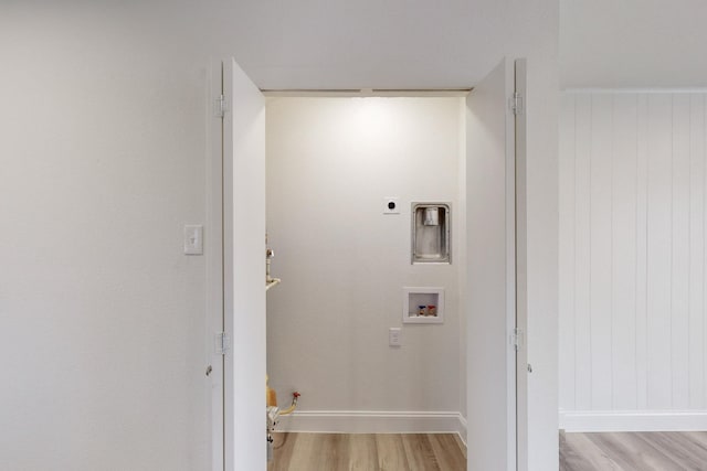 laundry room with gas dryer hookup, light hardwood / wood-style flooring, washer hookup, and hookup for an electric dryer