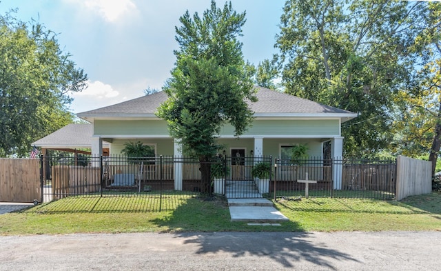 view of front of home with a front yard, a porch, and a carport