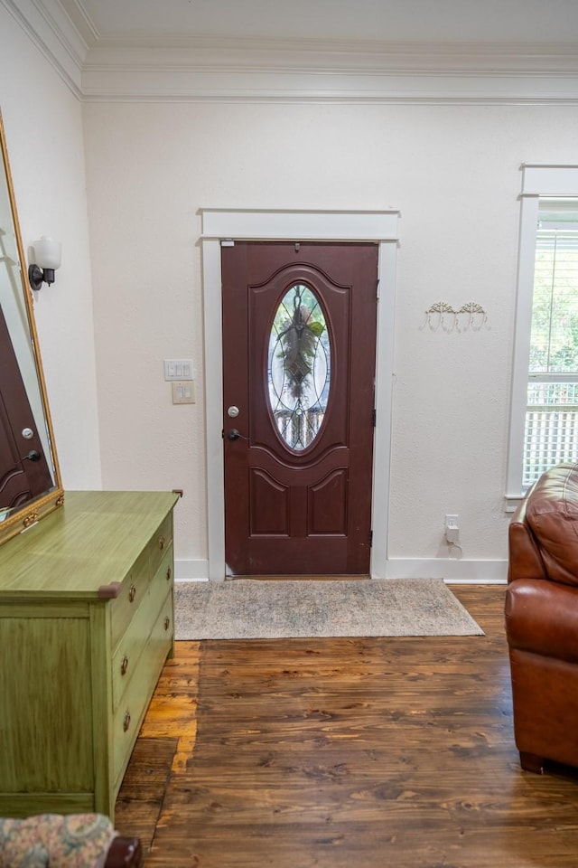 entrance foyer with dark wood-type flooring and ornamental molding